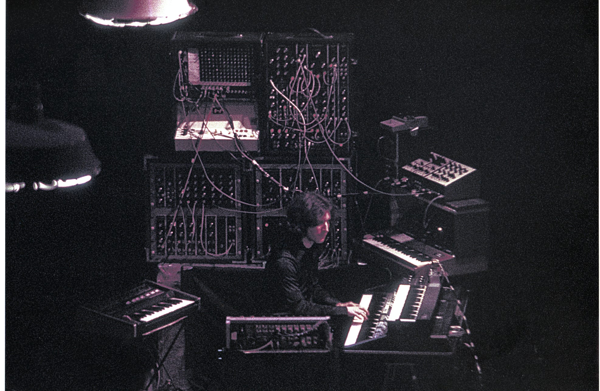 Music Producer Sitting in a Studio in front of a Computer and Console 